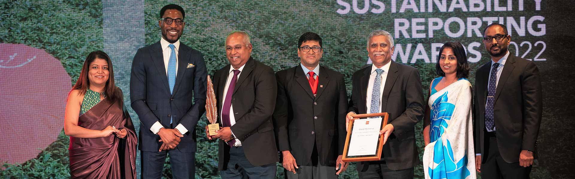 Mr. Gahanath Pandithage, Group CEO of DIMO; Mr. Suresh Gooneratne, Director / CFO of DIMO; Mr. Sudath Mahagedara, General Manager - Finance of DIMO; and Ms. Thilini Fernando, Manager - Accounts Receivable of DIMO accepting the overall Runner-up award.